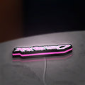 Hatsune Miku LED lightbox lying flat on a desk with pink glow