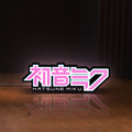 Front view of Hatsune Miku LED lightbox sign glowing on a wooden desk