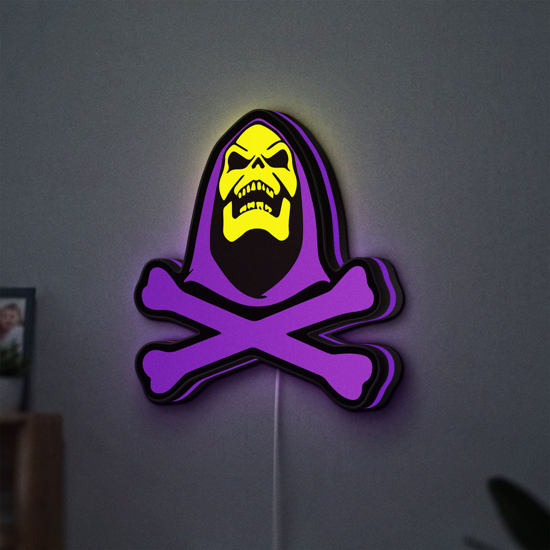 Skeletor LED lightbox hanging on a wall with purple glow