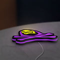 Skeletor LED lightbox lying flat on a desk with purple glow