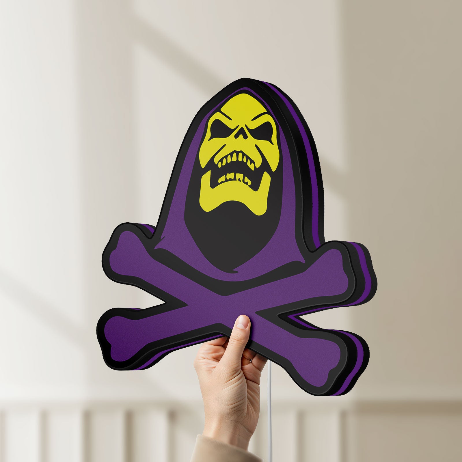 Unlit Skeletor LED lightbox held by hand to show size and details