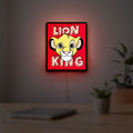 Simba Lion King LED lightbox hanging on a room wall with soft red light