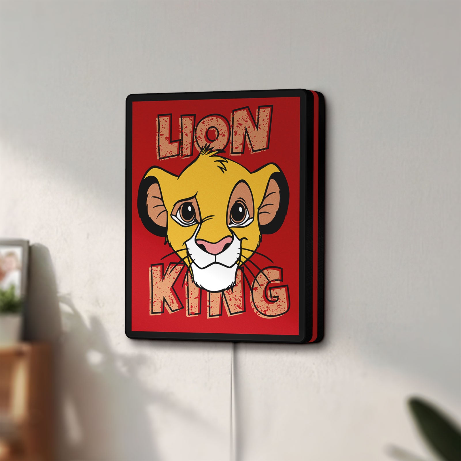 Unlit Simba Lion King LED lightbox mounted on a wall in daylight