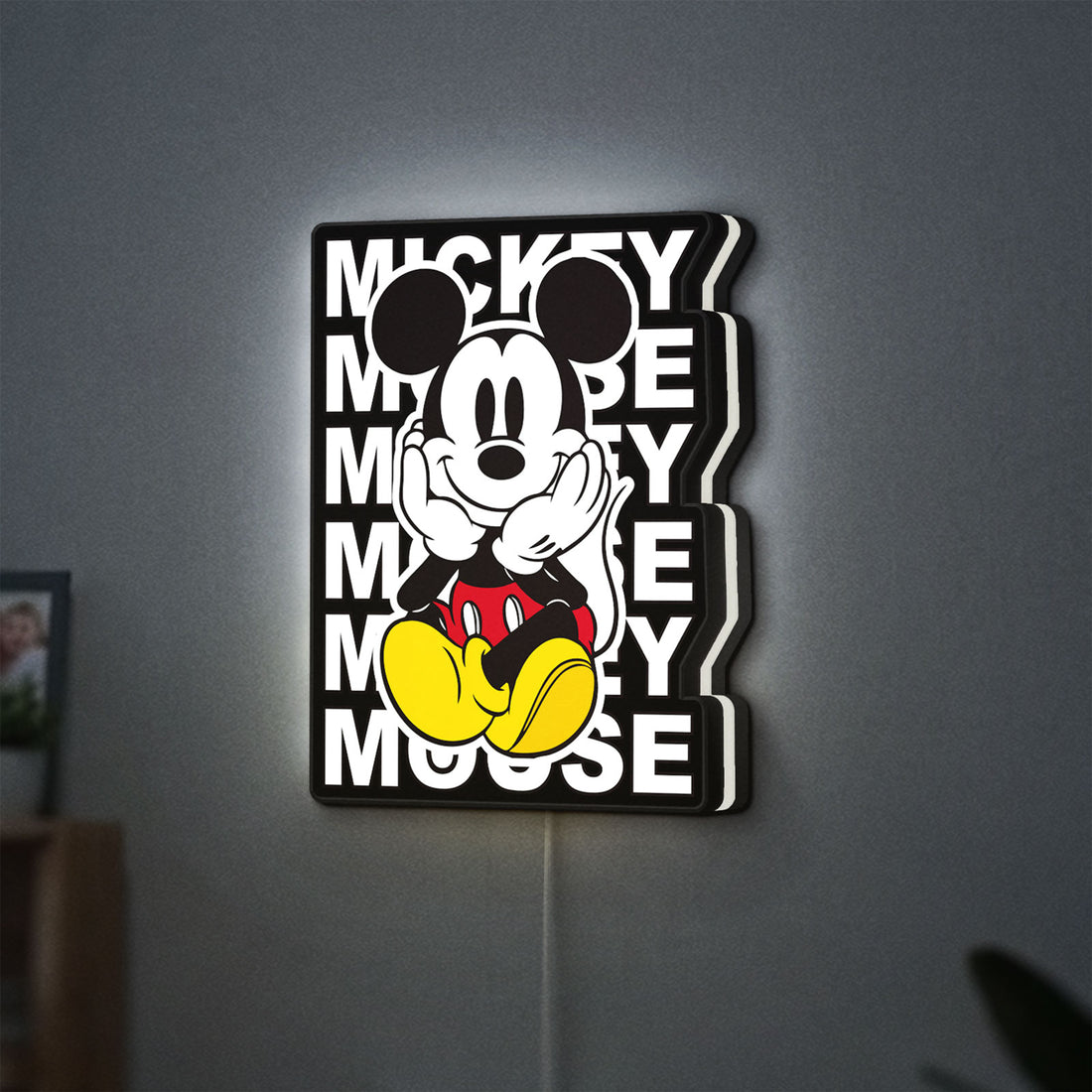 Mickey Mouse LED lightbox hanging on a wall with white glow