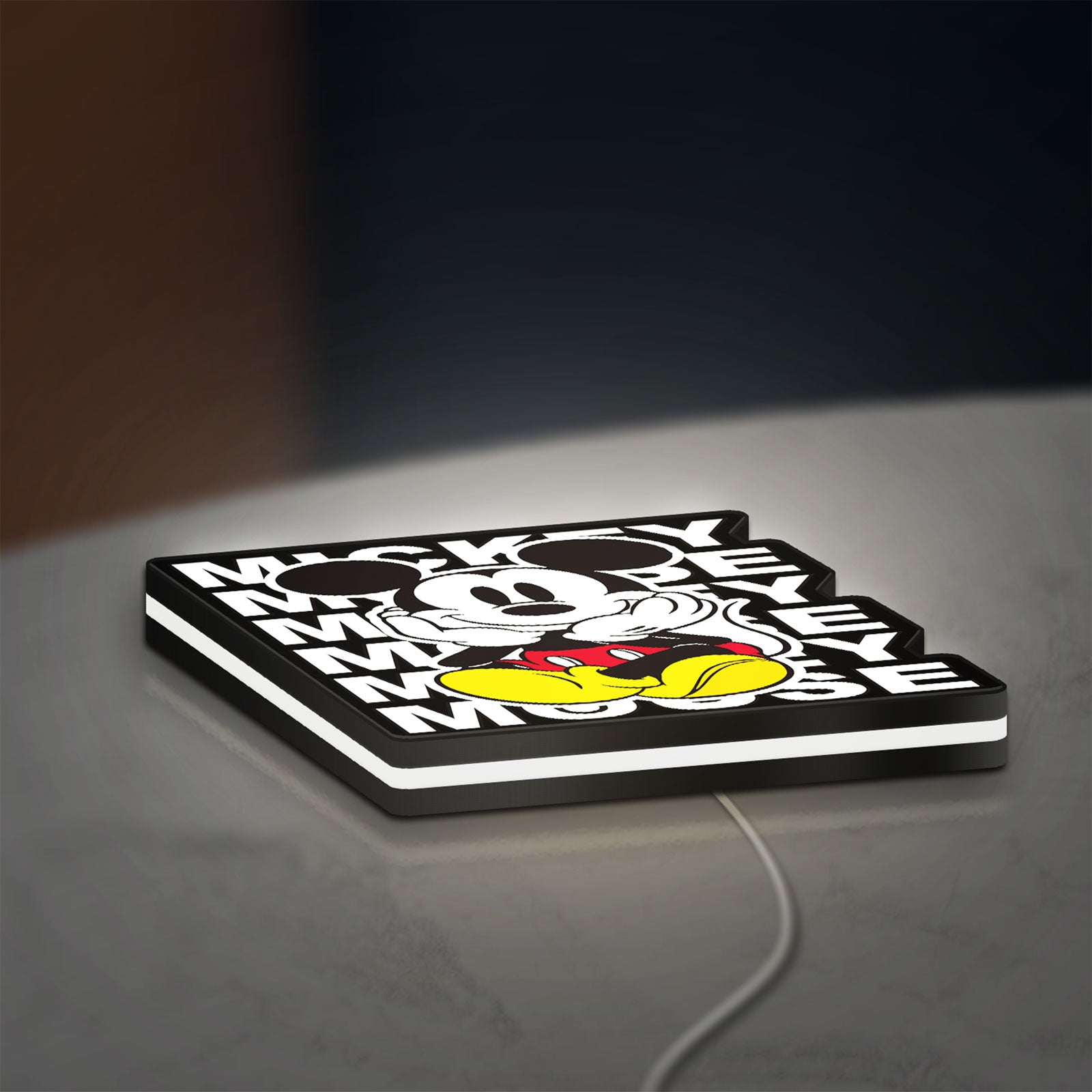 Mickey Mouse LED lightbox lying flat on a desk with white glow