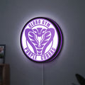 Dodgeball Globo Gym Purple Cobras LED lightbox hanging on a wall with purple glow