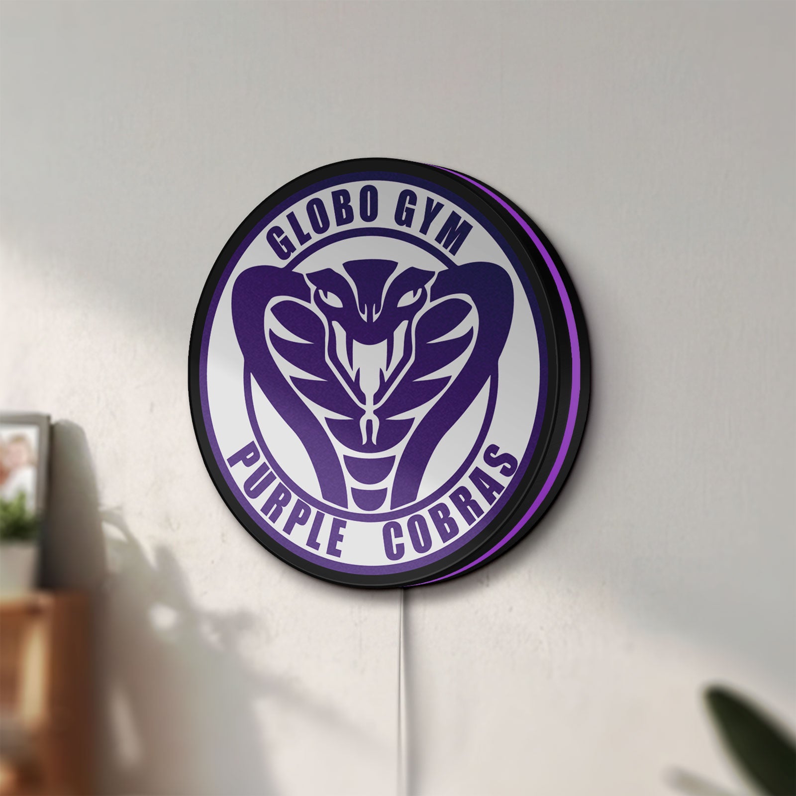Unlit Dodgeball Globo Gym Purple Cobras LED lightbox mounted on a wall in daylight