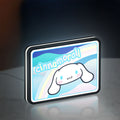 Cinnamoroll LED lightbox standing on a desk from an angled side view with white glow