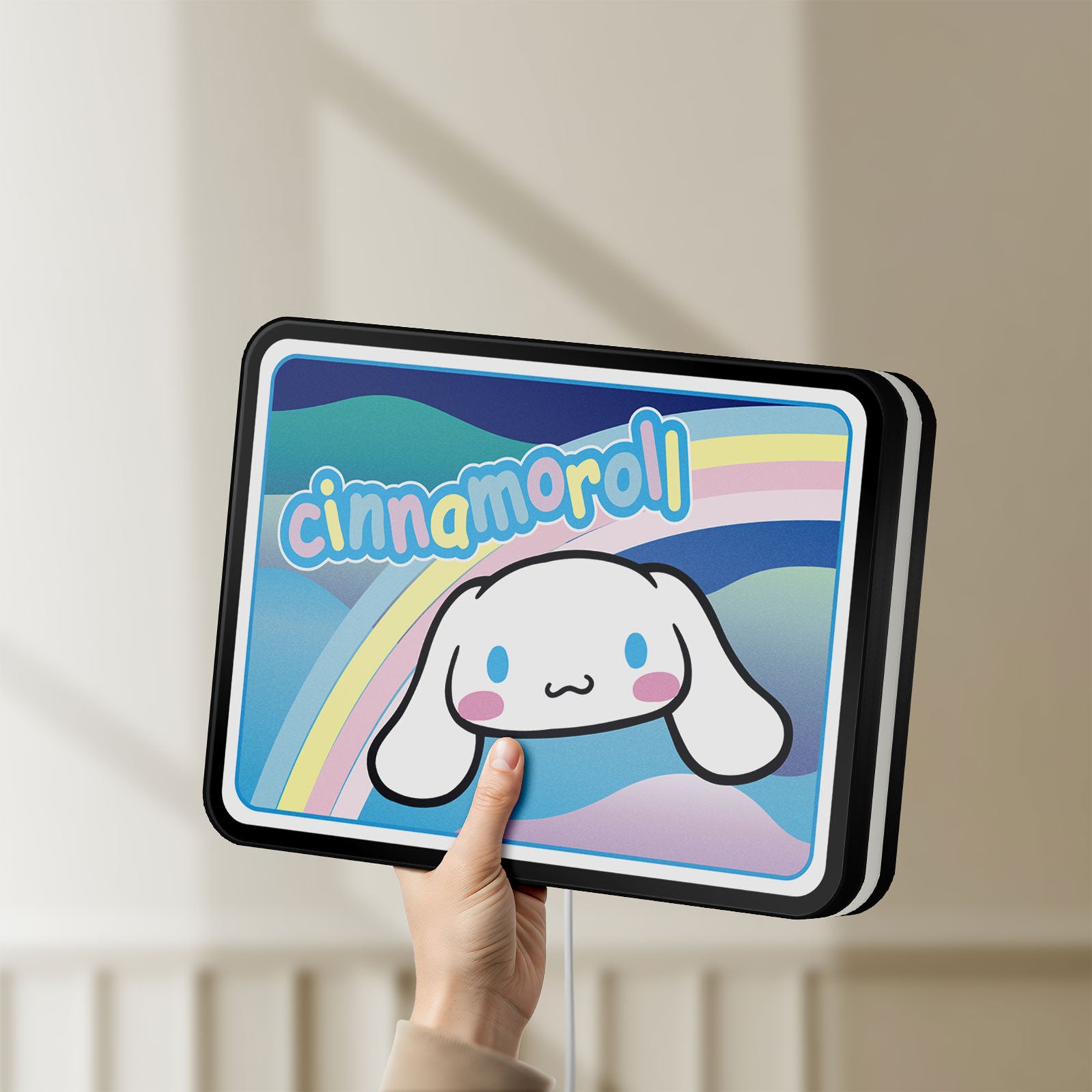 Unlit Cinnamoroll LED lightbox held by hand to show size and details