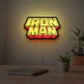 Iron Man LED lightbox hanging on a room wall with soft yellow light