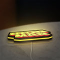 Iron Man LED lightbox lying flat on a desk with yellow glow