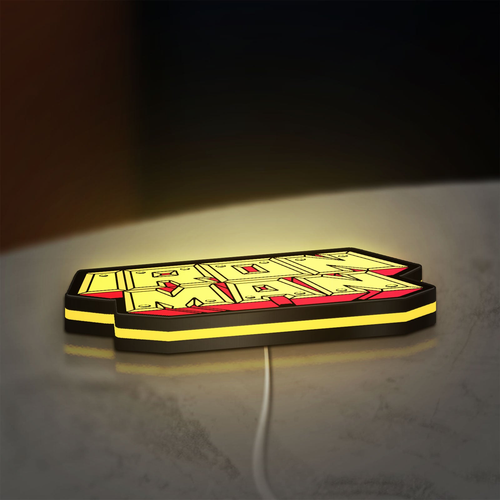 Iron Man LED lightbox lying flat on a desk with yellow glow