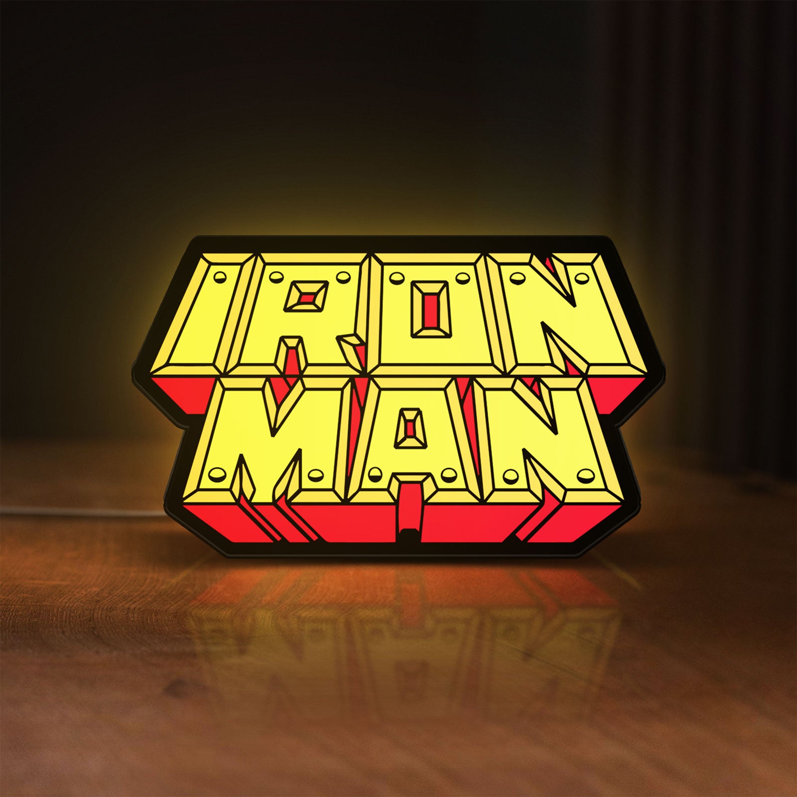 Front view of Iron Man LED lightbox sign glowing on a wooden desk