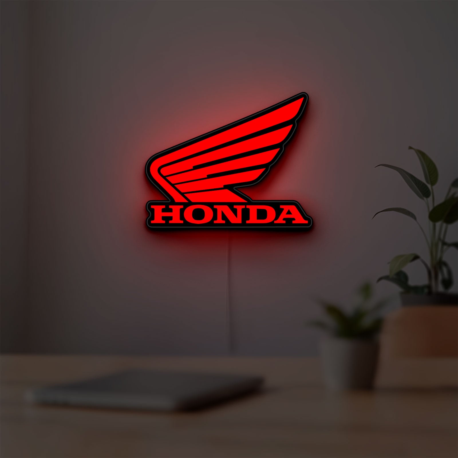 Honda LED lightbox hanging on a room wall with soft red light