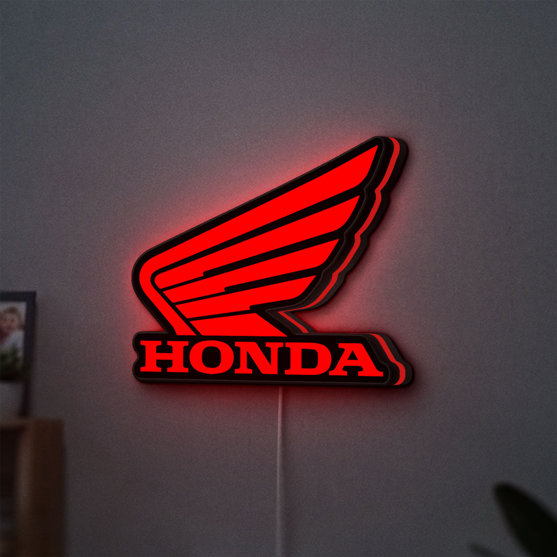Honda LED lightbox hanging on a wall with red glow