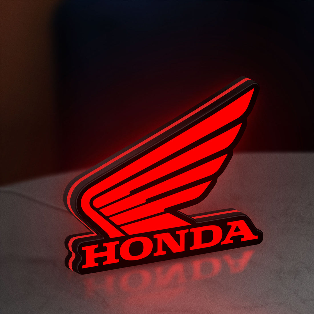 Honda LED lightbox hanging on a wall with red glow