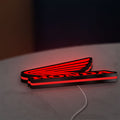 Honda LED lightbox lying flat on a desk with red glow