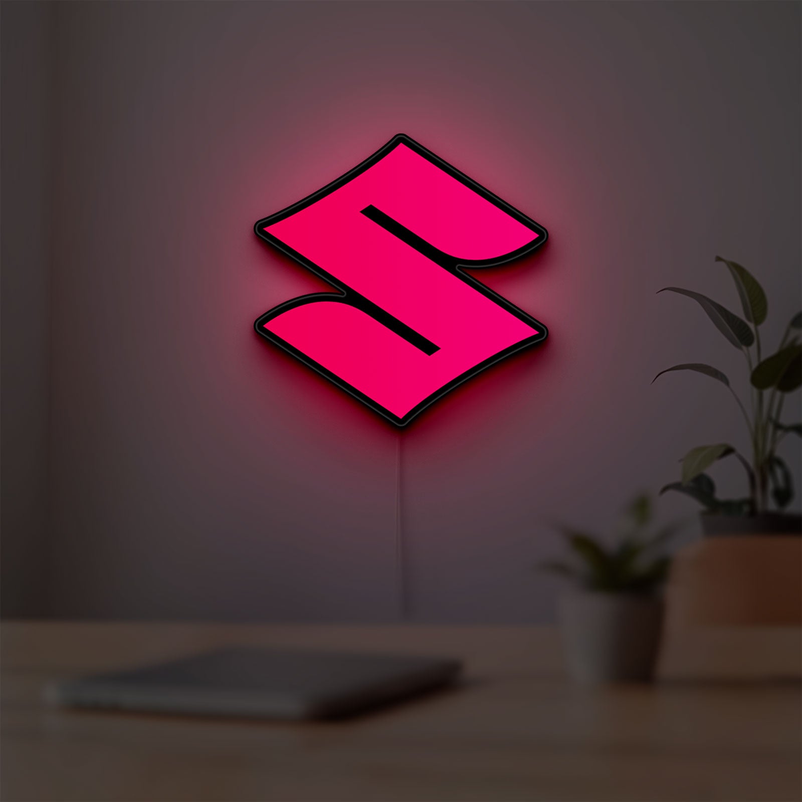 Suzuki LED lightbox hanging on a room wall with soft red light