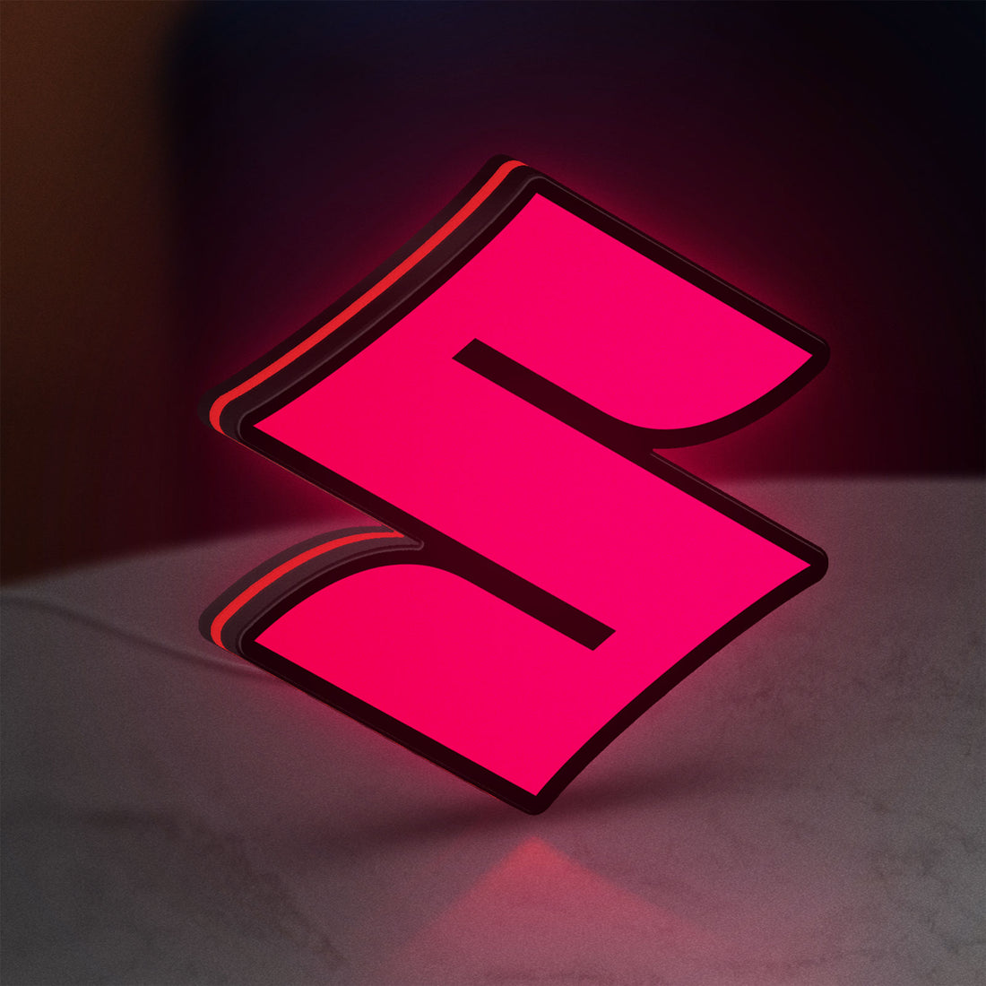 Suzuki LED lightbox hanging on a wall with red glow