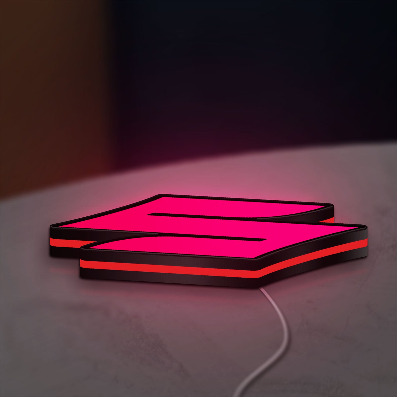Suzuki LED lightbox lying flat on a desk with red glow