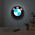 BMW LED lightbox hanging on a room wall with soft white light