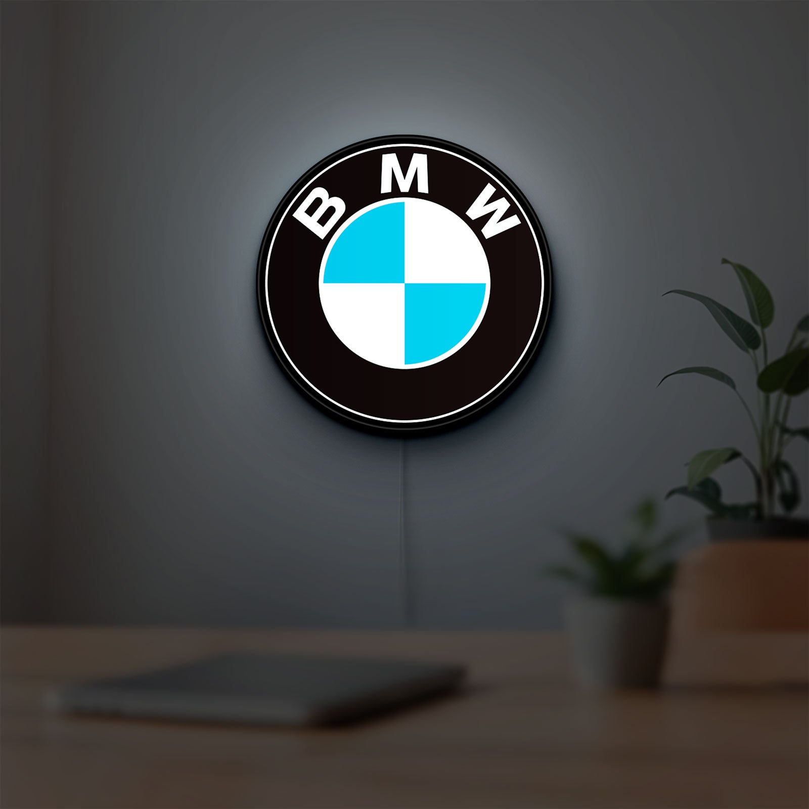 BMW LED lightbox hanging on a room wall with soft white light