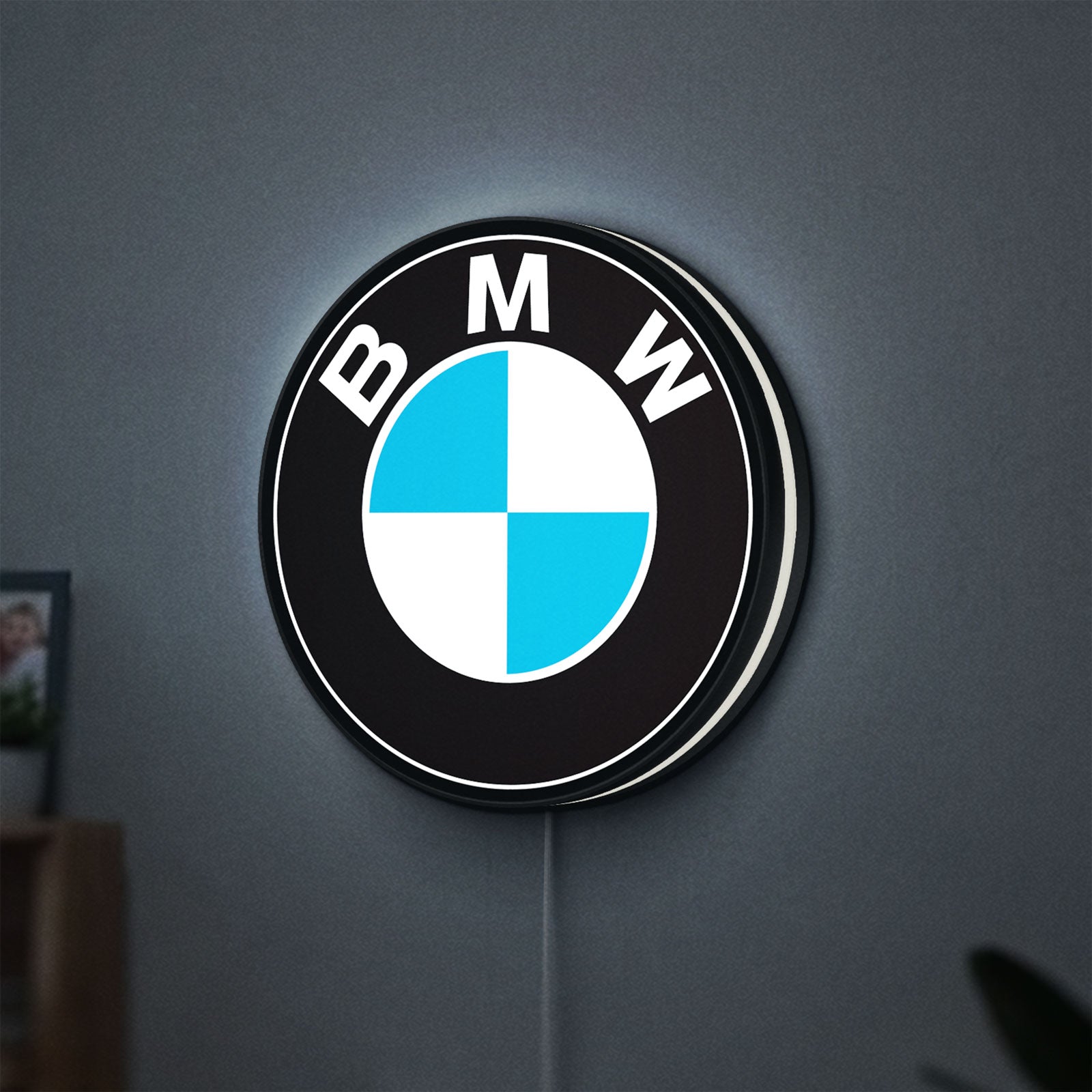 BMW LED lightbox hanging on a wall with white glow