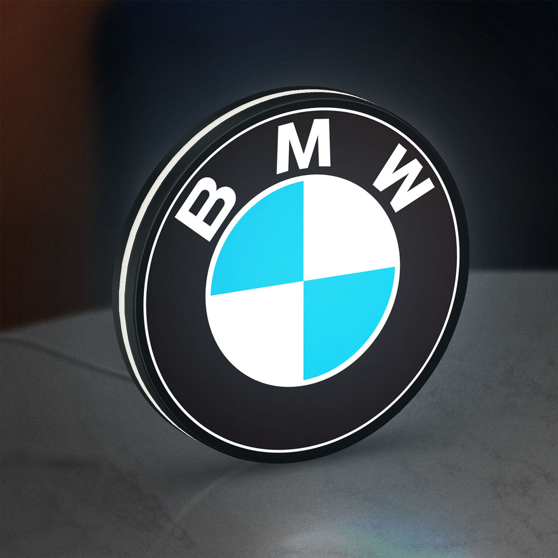BMW LED lightbox hanging on a wall with white glow