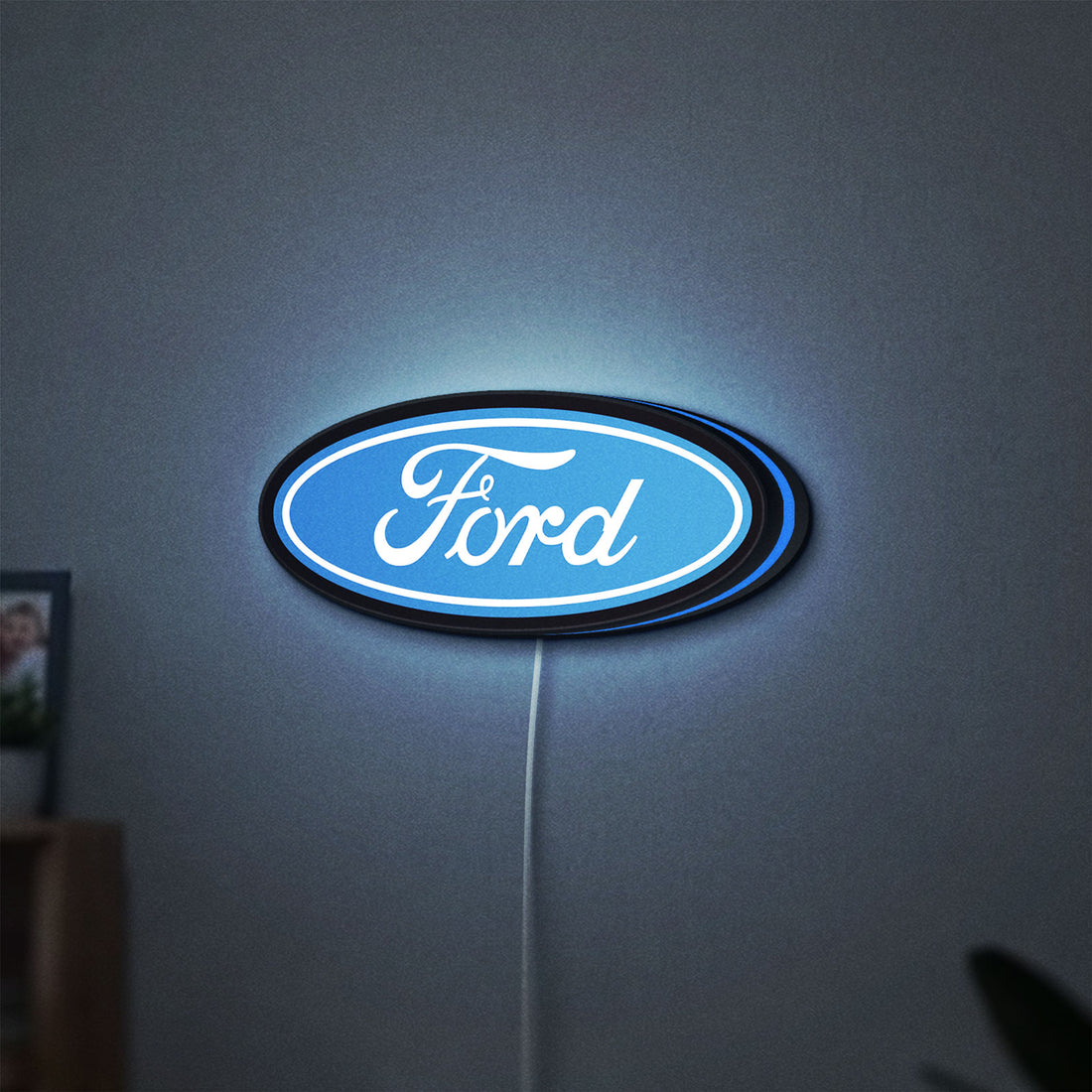Ford LED lightbox hanging on a wall with blue glow