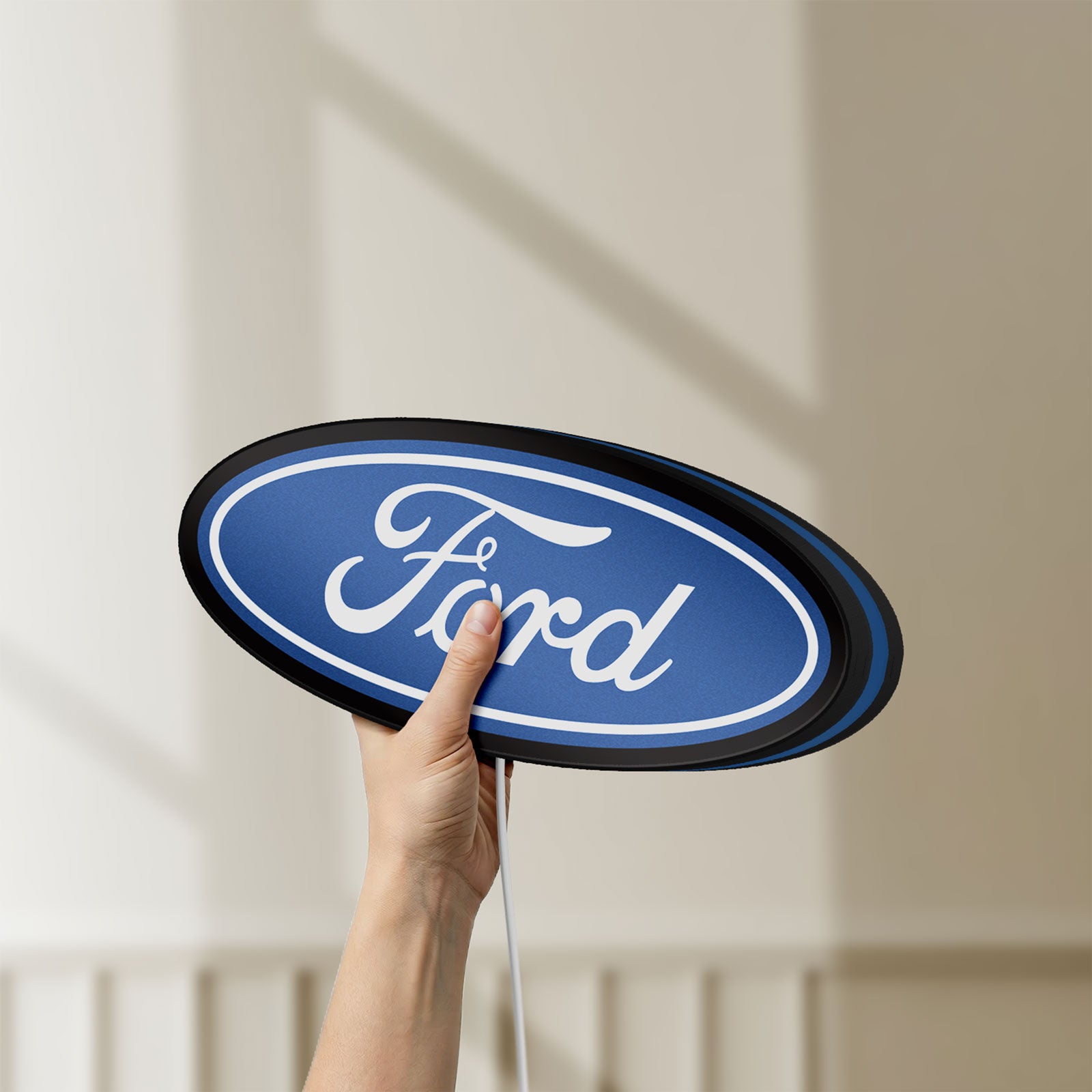Unlit Ford LED lightbox held by hand to show size and details