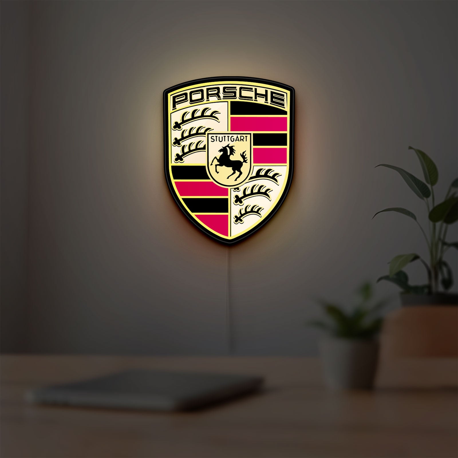 Porsche LED lightbox hanging on a room wall with soft yellow light