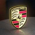 Porsche LED lightbox standing on a desk from an angled side view with yellow glow