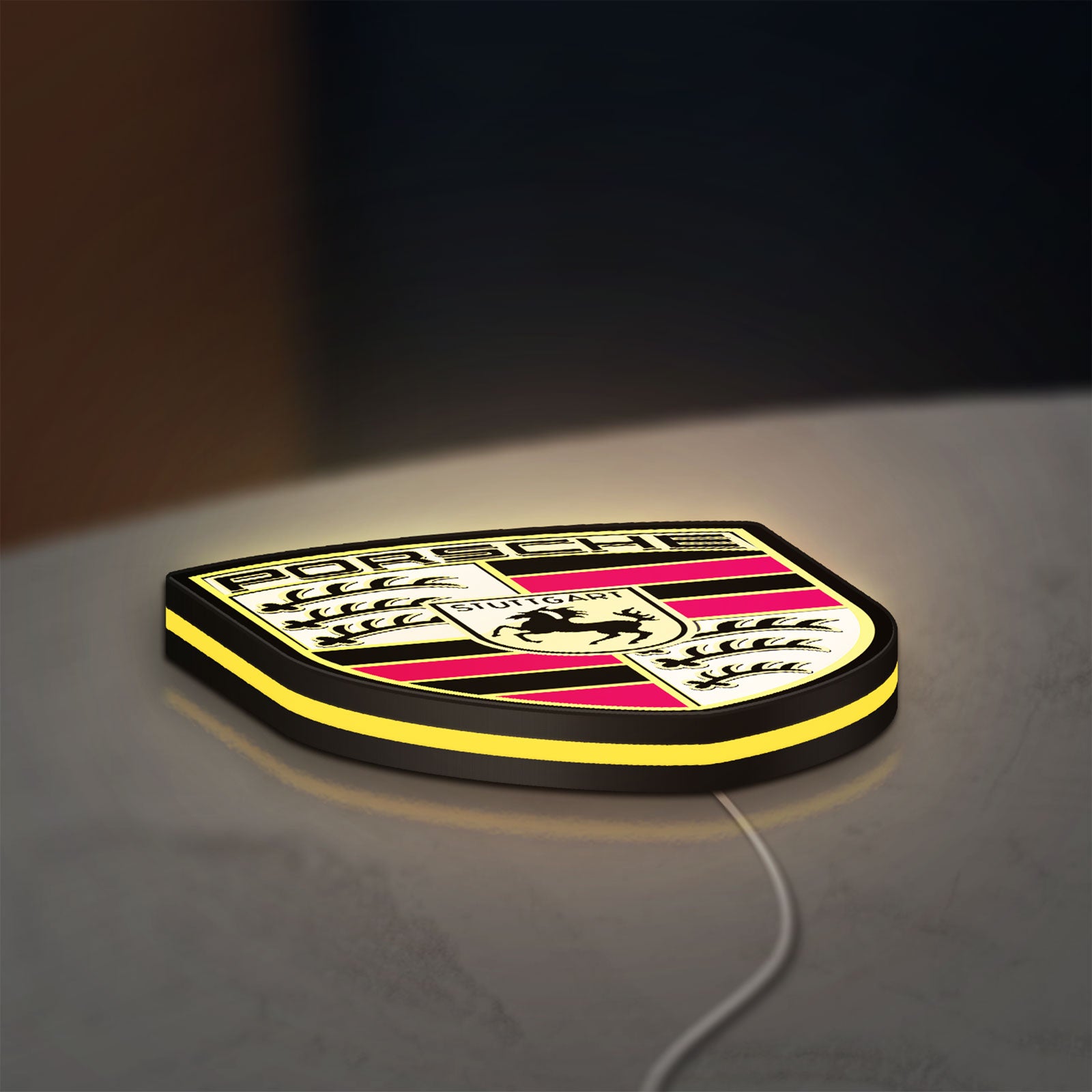 Porsche LED lightbox lying flat on a desk with yellow glow