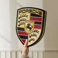 Unlit Porsche LED lightbox held by hand to show size and details