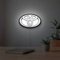 Toyota LED lightbox hanging on a room wall with soft white light