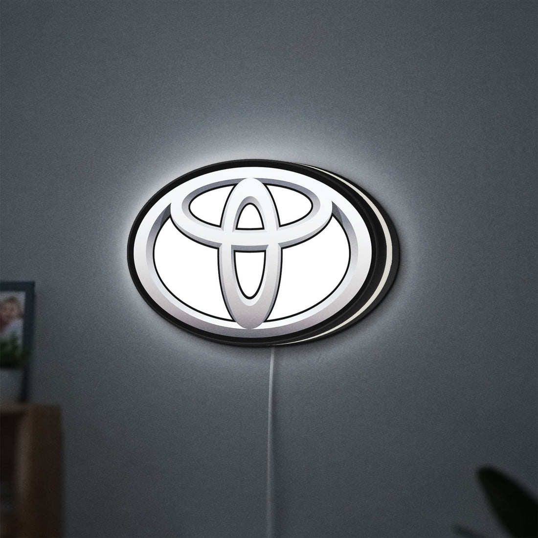 Toyota LED lightbox hanging on a wall with white glow