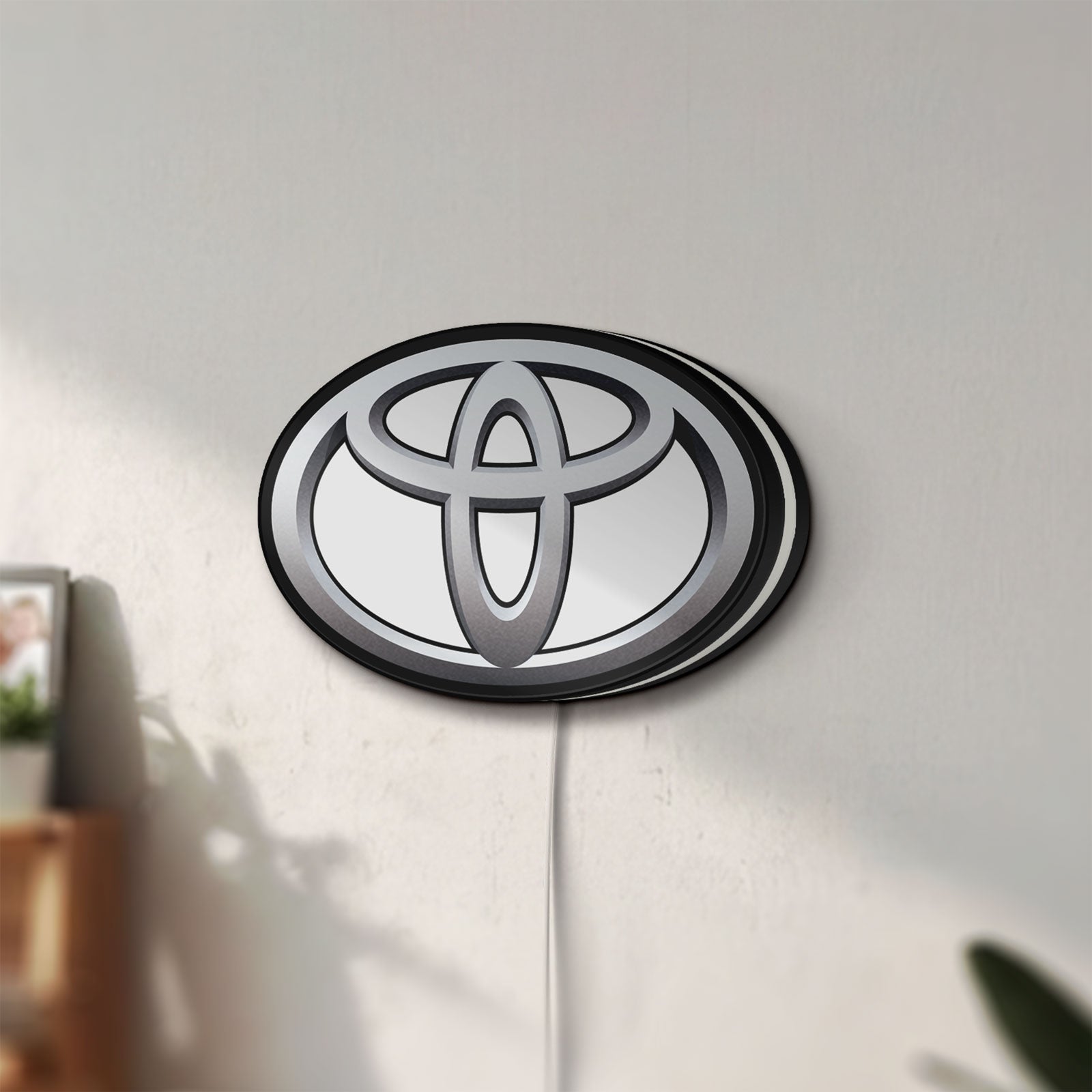 Unlit Toyota LED lightbox mounted on a wall in daylight