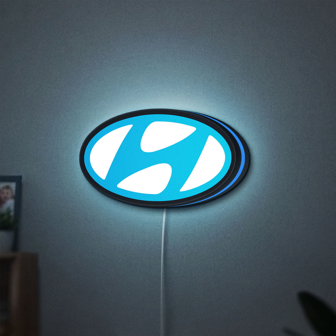 Hyundai LED lightbox hanging on a wall with blue glow