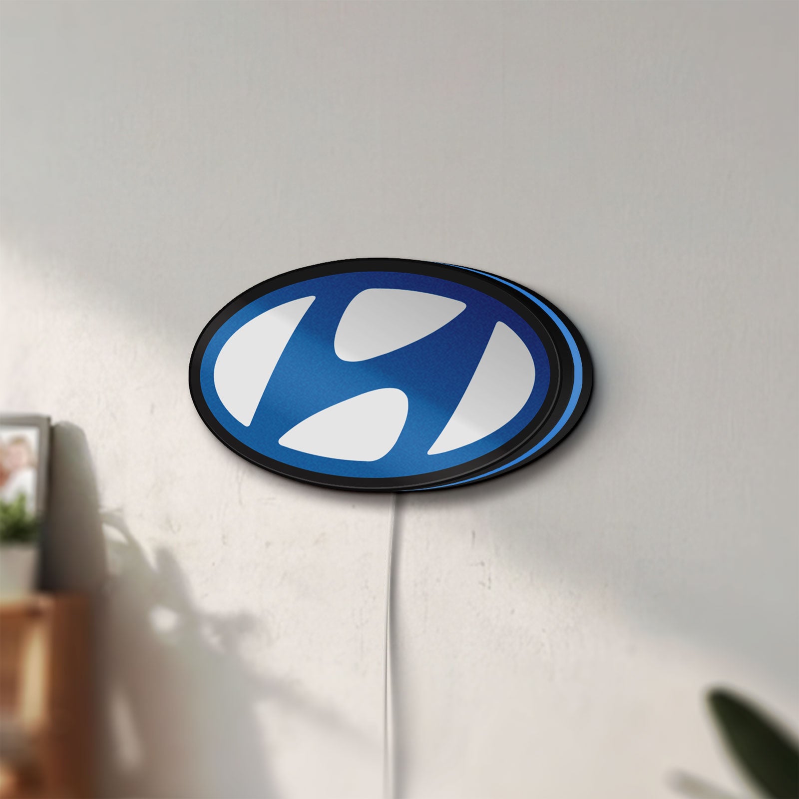Unlit Hyundai LED lightbox mounted on a wall in daylight