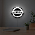 Nissan LED lightbox hanging on a room wall with soft white light
