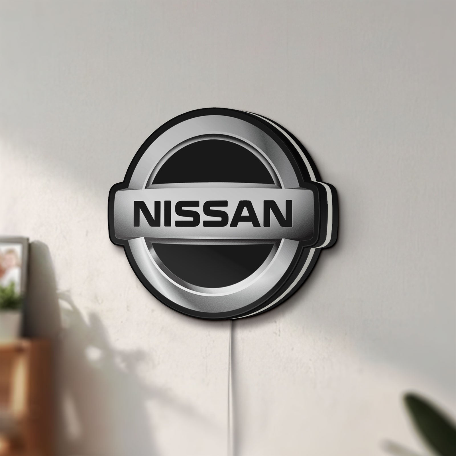 Unlit Nissan LED lightbox mounted on a wall in daylight