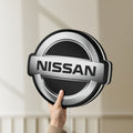 Unlit Nissan LED lightbox held by hand to show size and details