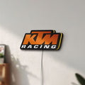 Unlit KTM Racing LED lightbox mounted on a wall in daylight