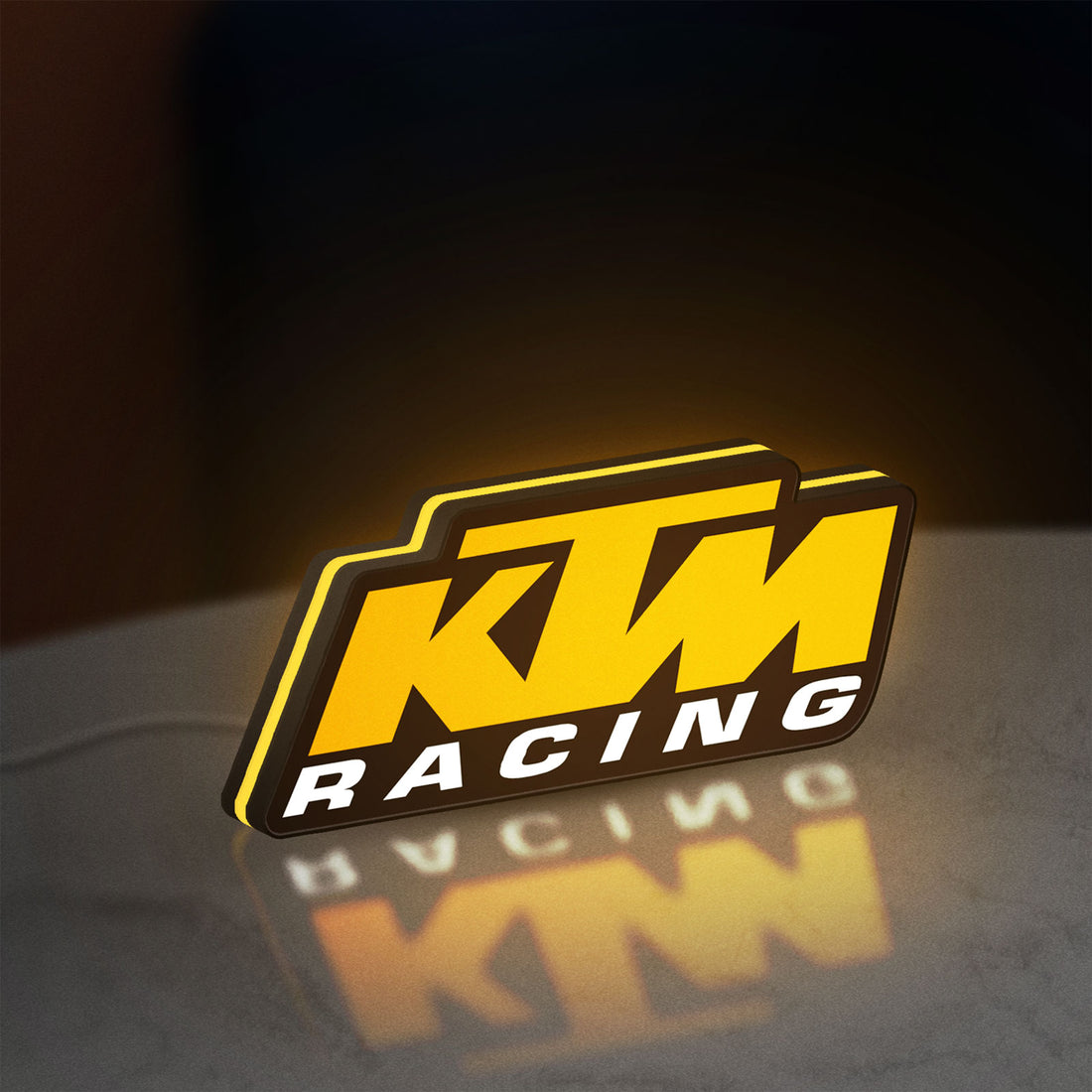 KTM Racing LED lightbox hanging on a wall with yellow glow