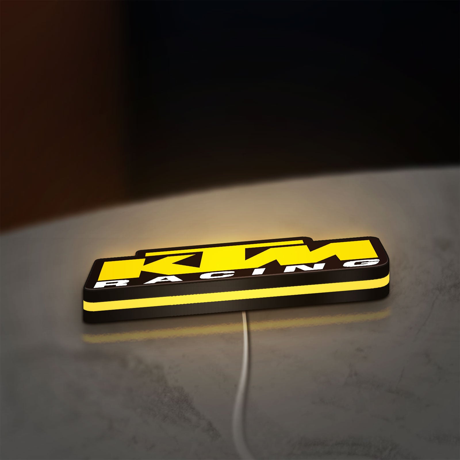 KTM Racing LED lightbox lying flat on a desk with yellow glow