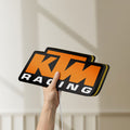 Unlit KTM Racing LED lightbox held by hand to show size and details