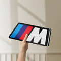 Unlit BMW M LED lightbox held by hand to show size and details