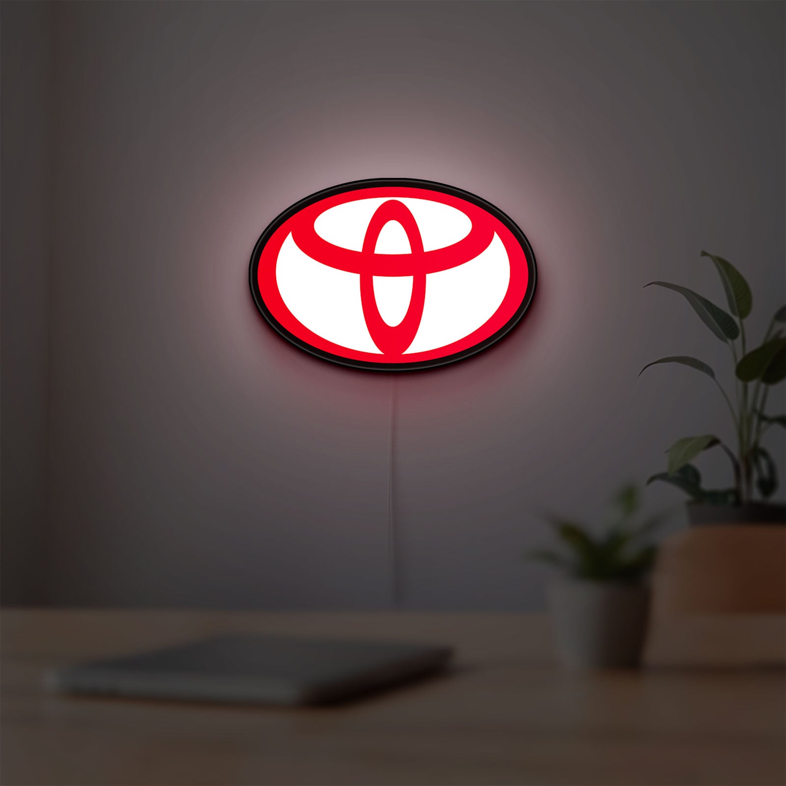 Toyota LED lightbox hanging on a room wall with soft red light
