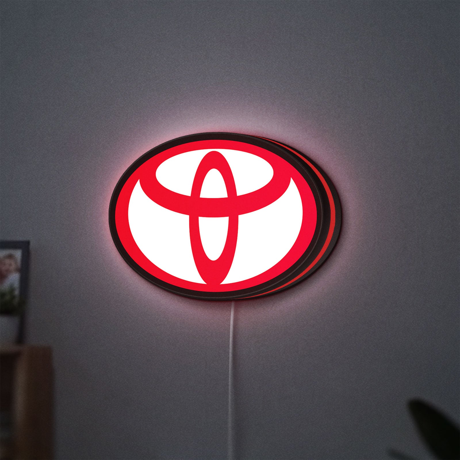Toyota LED lightbox hanging on a wall with red glow