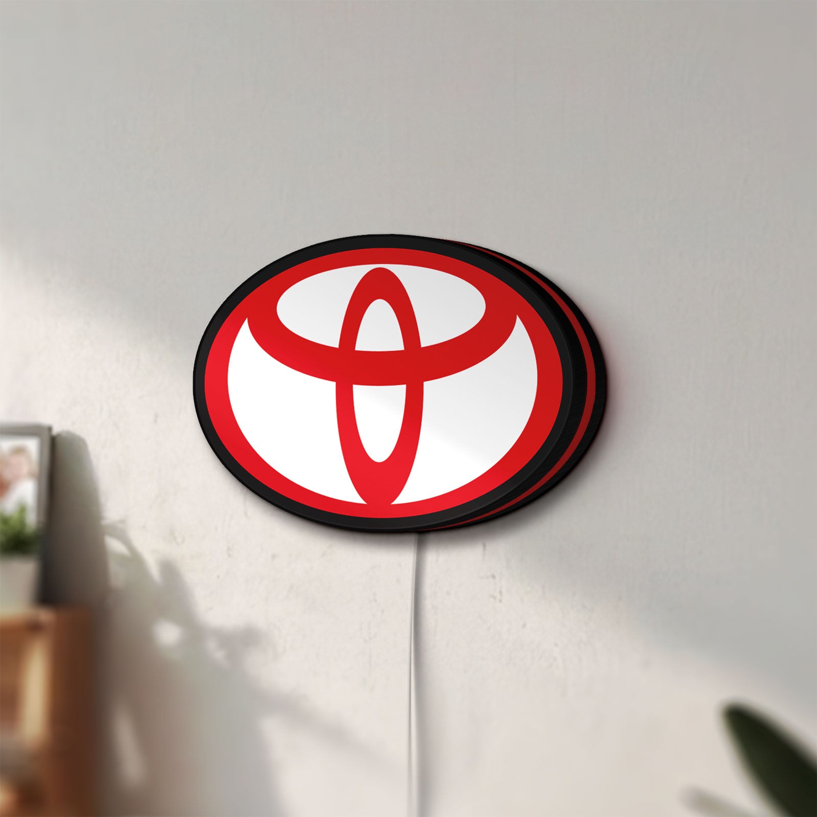 Unlit Toyota LED lightbox mounted on a wall in daylight
